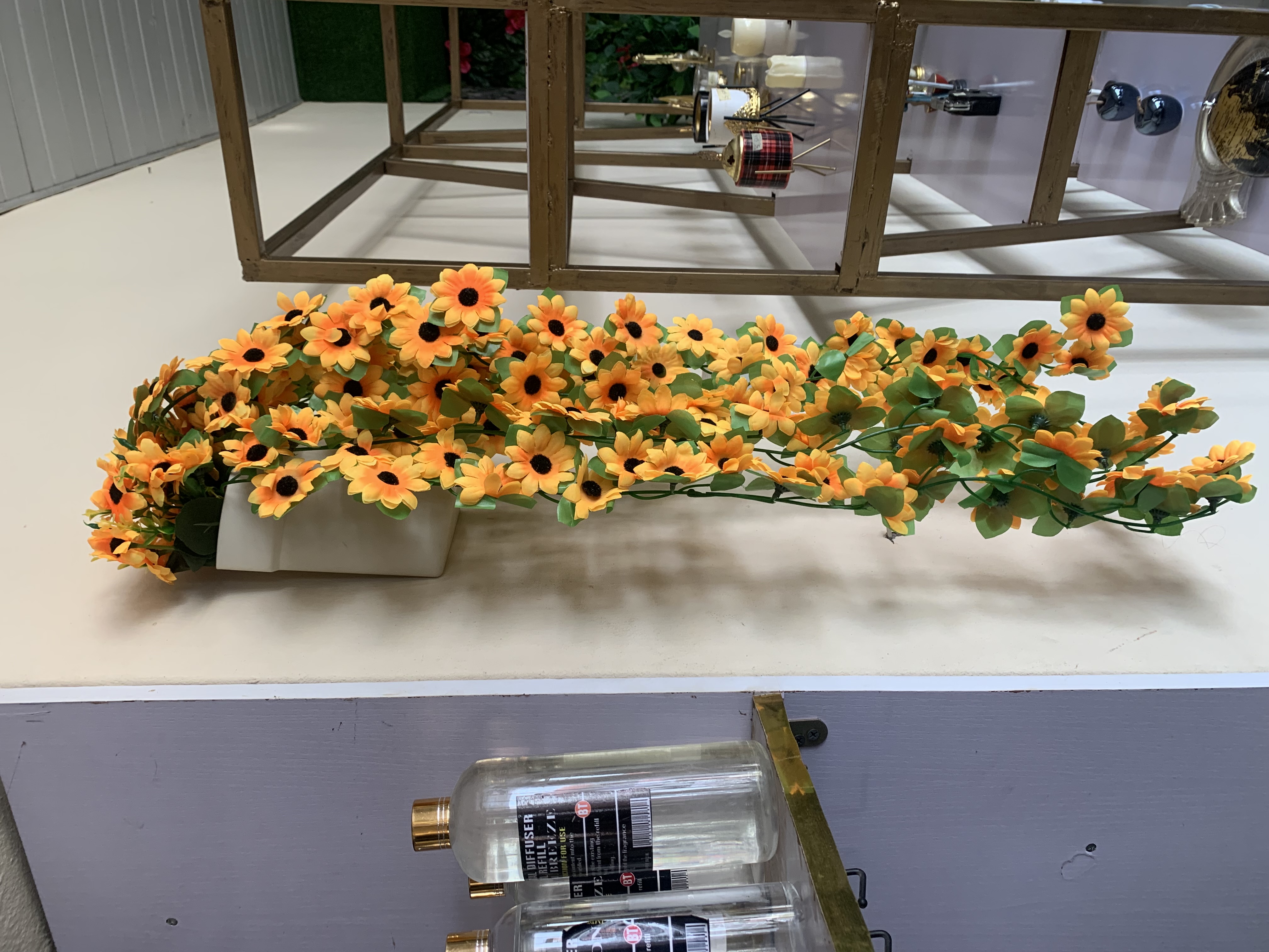 Dropping sunflowers in plastic wall vase Image